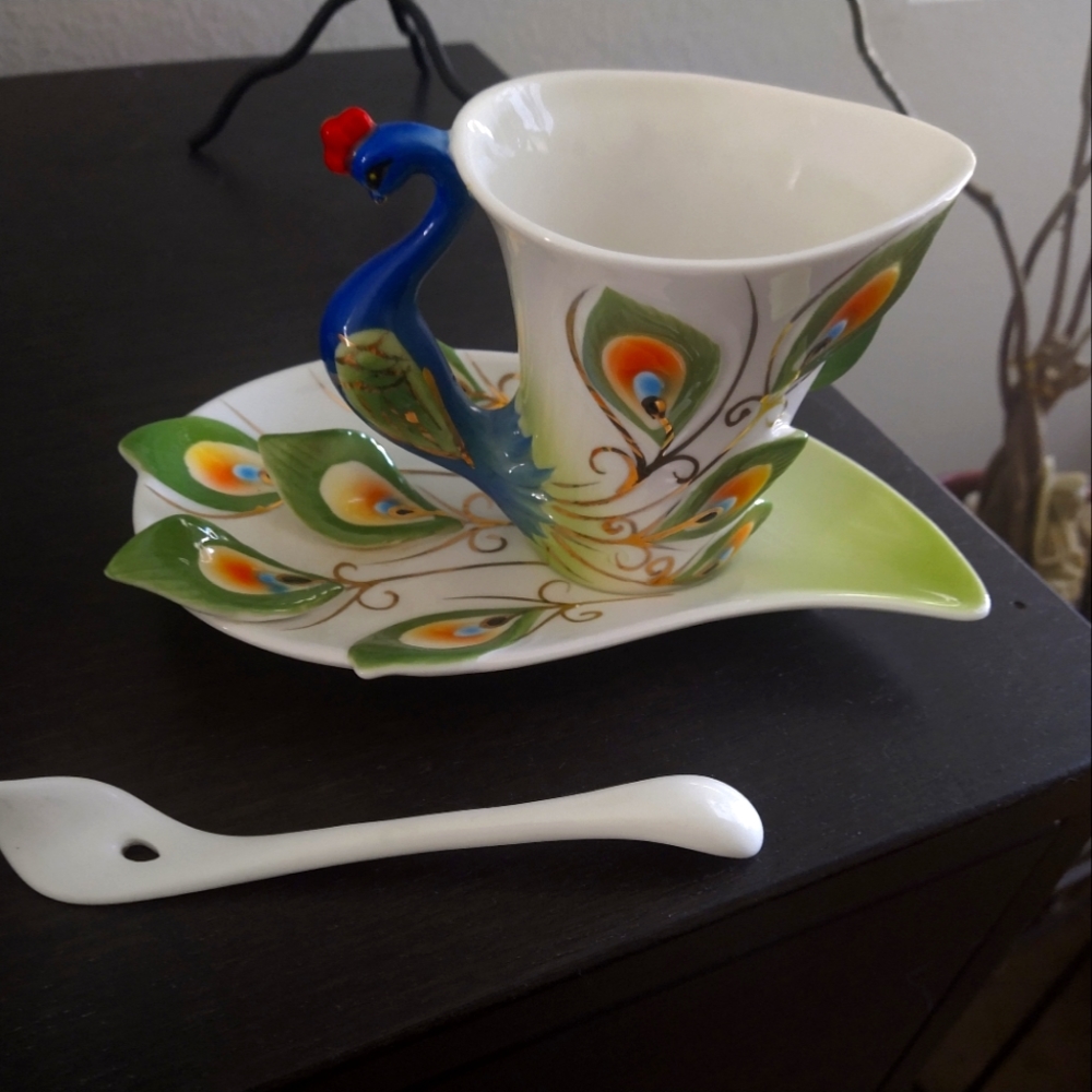 Sculpted glass tea cup and saucer